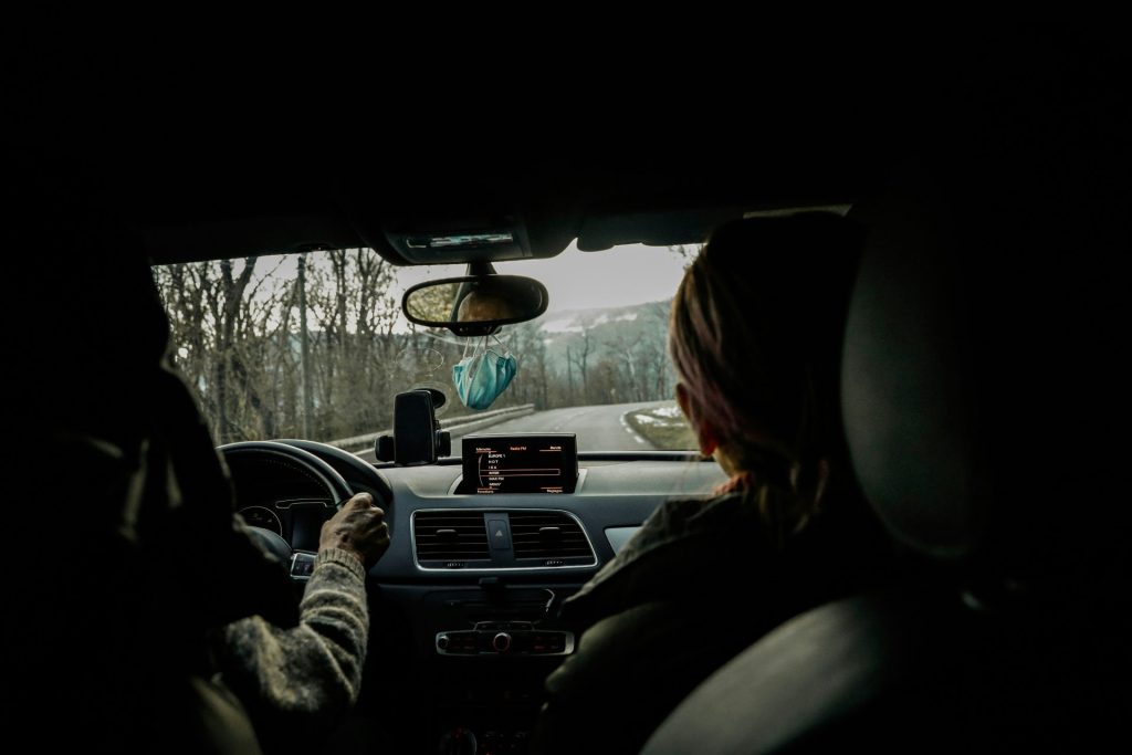 a woman driving a car in the dark